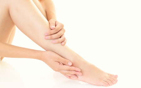 マッサージ効果で脚をリフレッシュする女性