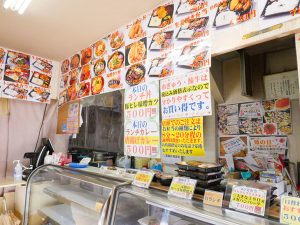 店の壁いっぱいに写真入り弁当メニュー。日替わりメニューは500円～とリーズナブル