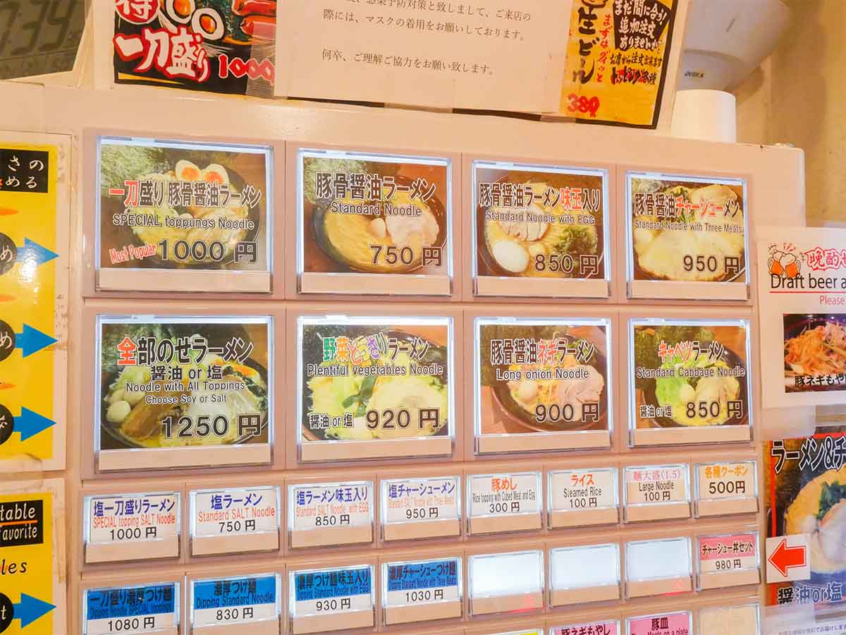 券売機。写真を見ると、どれもボリュームが凄そう。日本語の下に英語表記があるのも、赤坂ならでは