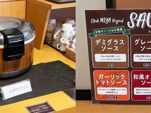 （左）着丼時にライスがサーブされた後、おかわりしたい人は自分でライスを盛り付ける仕組み（追加料金なし）。（右）5種類ある「オリジナルソース」は、名物「宮のたれ」を筆頭に、「デミグラスソース」「グレービーソース」「ガーリックトマトソース」「和風オニオンソース」があります。この他テーブルには塩・胡椒もあります