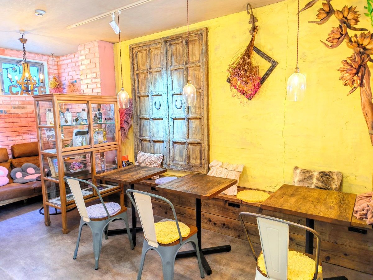 花や雑貨、アンティーク家具が並ぶやわらかな雰囲気の空間