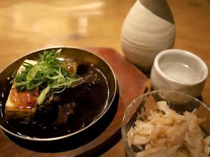 左：謹製デミ味噌牛煮込み 690円、右：梅水晶350円、熱燗1合490円