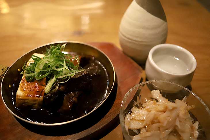 左:謹製デミ味噌牛煮込み 690円、右:梅水晶350円、熱燗1合490円